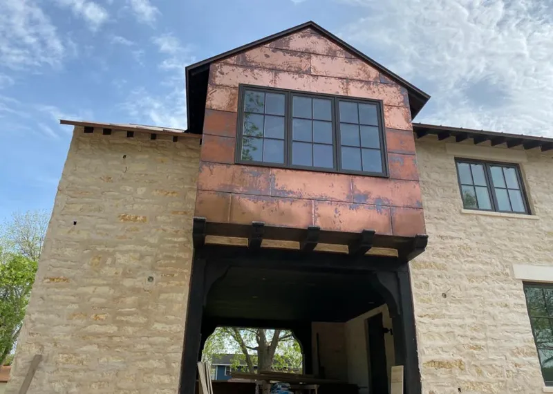 Copper metal panel facade on a stone building for Skylight Installation in Lake of the Pines