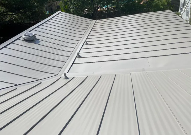 Solar attic fan installed on a metal roof for Roof Ventilation in Lake of the Pines